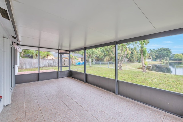 unfurnished sunroom featuring a water view and a healthy amount of sunlight