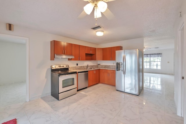 kitchen featuring ceiling fan, sink, stainless steel appliances, and a textured ceiling