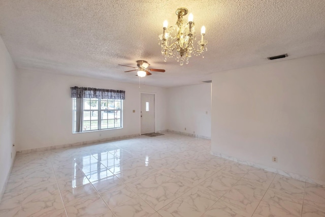 spare room featuring a textured ceiling and ceiling fan with notable chandelier