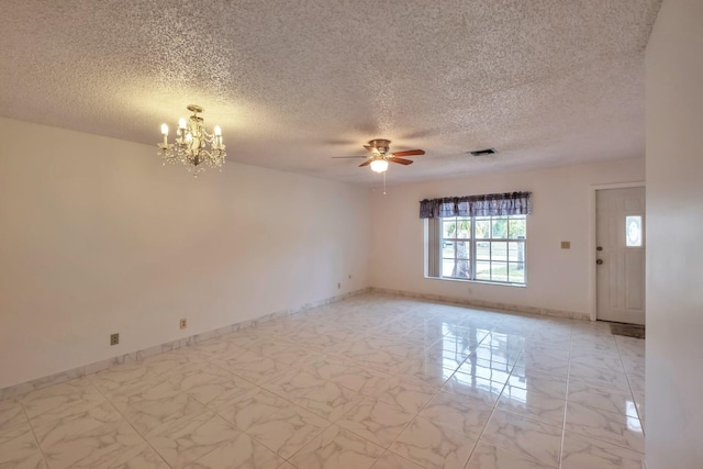 empty room featuring ceiling fan with notable chandelier