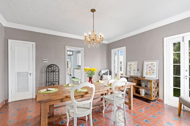 dining area with french doors, a chandelier, and ornamental molding