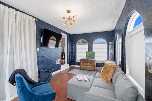 living room with a notable chandelier and a textured ceiling