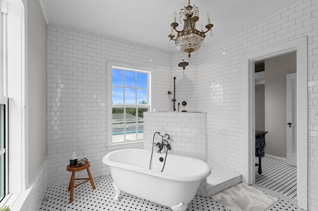 bathroom with tile walls, a notable chandelier, tile patterned floors, and shower with separate bathtub