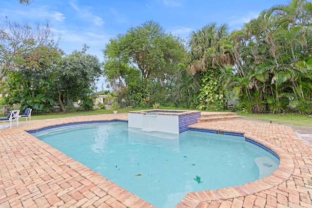 view of pool featuring a patio area and an in ground hot tub