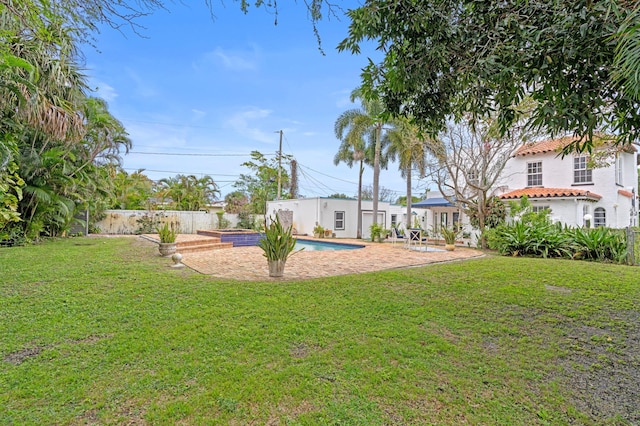 view of yard with a fenced in pool and a patio