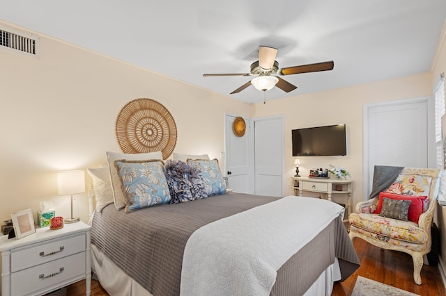 bedroom with ceiling fan and dark hardwood / wood-style flooring