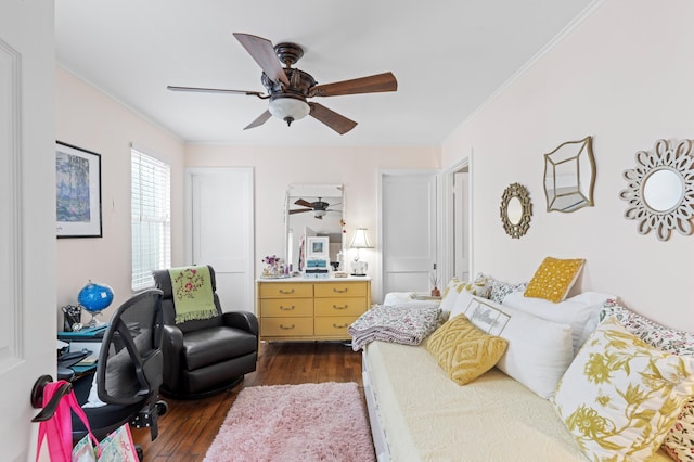 bedroom featuring dark wood-type flooring, ceiling fan, and crown molding