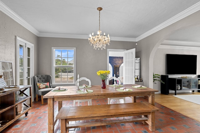 dining room with an inviting chandelier and crown molding