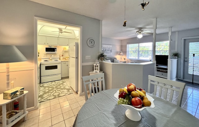 kitchen with ceiling fan, light tile patterned floors, tasteful backsplash, and white appliances