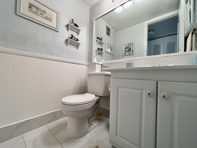 bathroom featuring toilet and vanity