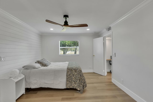 bedroom featuring crown molding, ceiling fan, wood walls, and light wood-type flooring