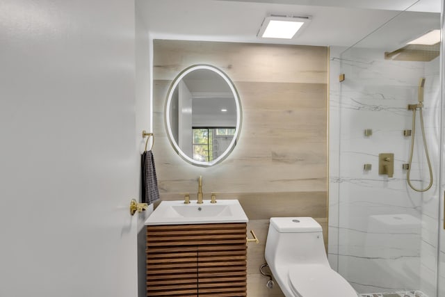 bathroom with vanity, toilet, and a shower