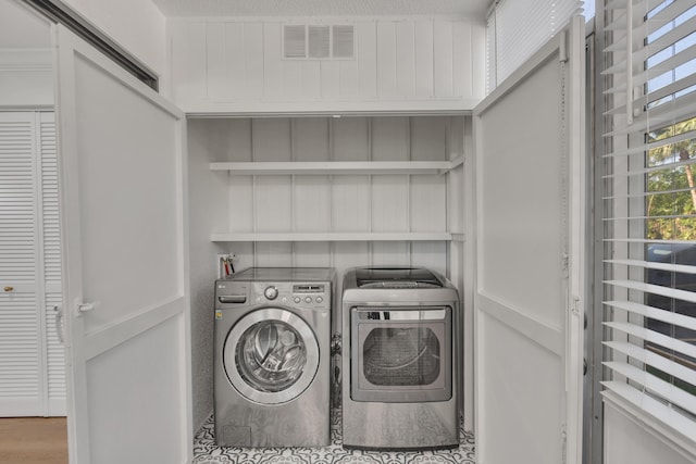 washroom featuring washer and dryer