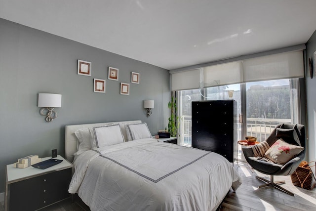 bedroom featuring wood-type flooring and multiple windows