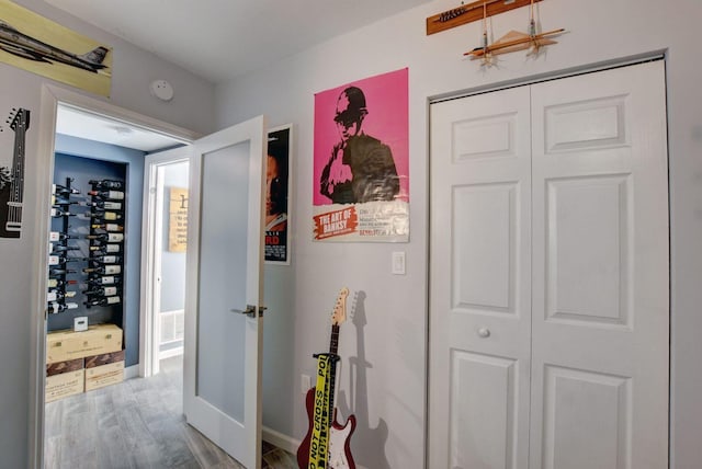 hallway with hardwood / wood-style flooring