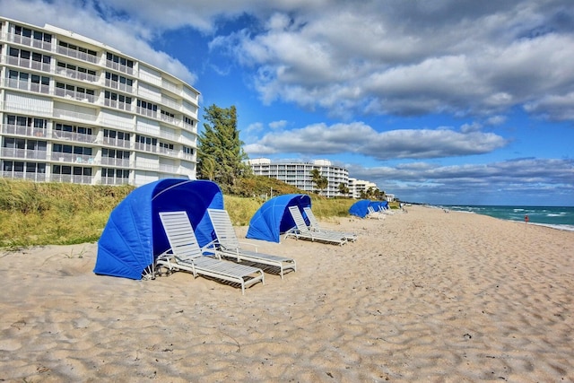 view of home's community featuring a beach view and a water view