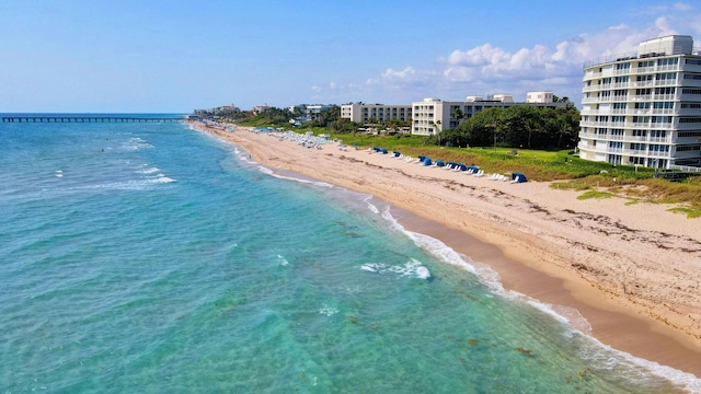 birds eye view of property featuring a beach view and a water view