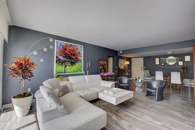 living room featuring a notable chandelier and hardwood / wood-style floors