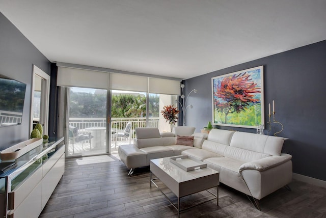 living room with floor to ceiling windows and dark wood-type flooring