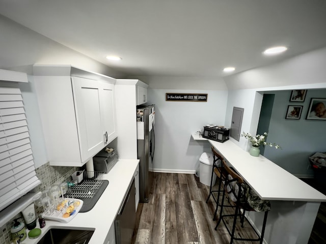 kitchen with a breakfast bar area, white cabinetry, tasteful backsplash, stainless steel fridge with ice dispenser, and dishwasher