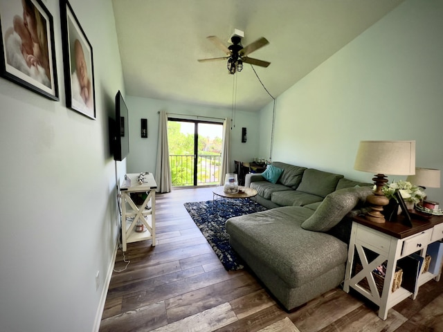 living room featuring lofted ceiling, hardwood / wood-style flooring, and ceiling fan