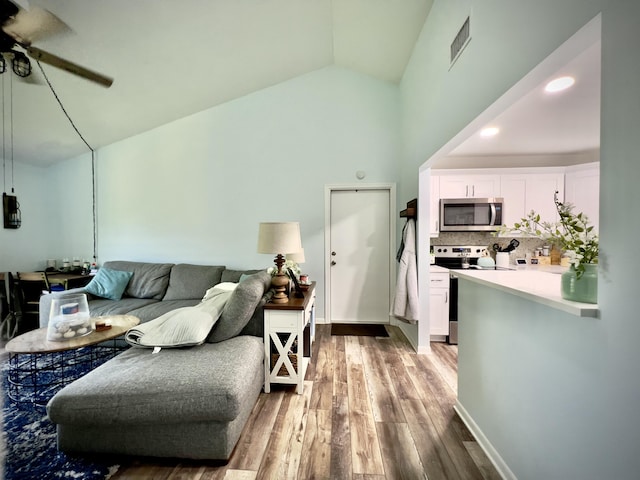 living room featuring ceiling fan, high vaulted ceiling, and light hardwood / wood-style floors