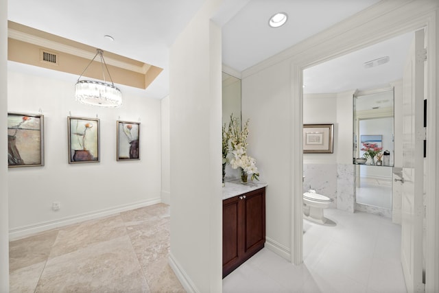 bathroom featuring ornamental molding, vanity, and toilet