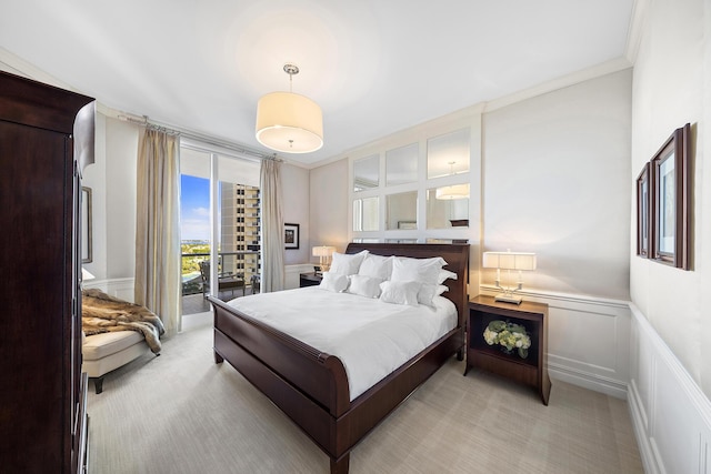 bedroom featuring access to exterior, ornamental molding, and light colored carpet