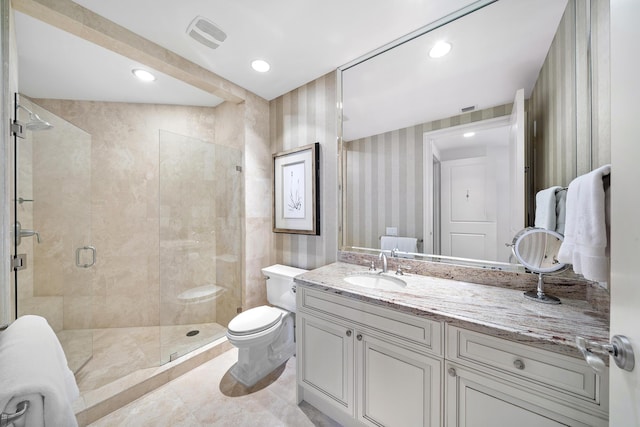 bathroom featuring a shower with door, vanity, and toilet