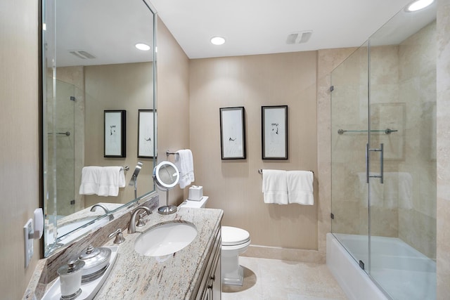 full bathroom featuring enclosed tub / shower combo, vanity, toilet, and tile patterned flooring