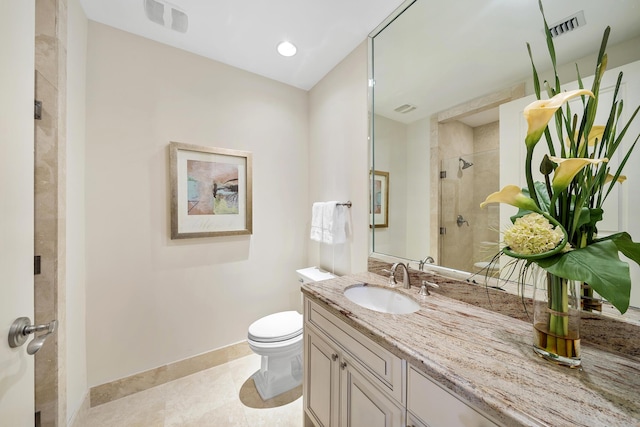 bathroom featuring vanity, tile patterned floors, toilet, and walk in shower