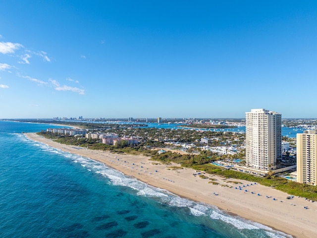 drone / aerial view with a water view and a beach view