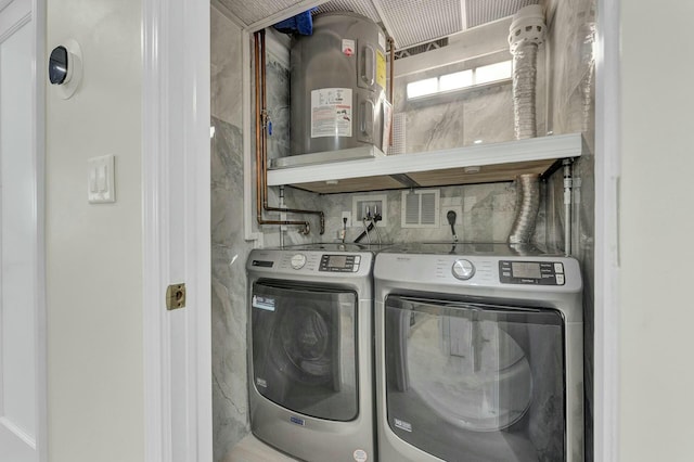 laundry area featuring washing machine and clothes dryer