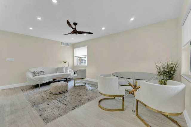 living room featuring ceiling fan and light hardwood / wood-style flooring