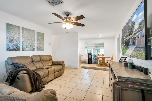 tiled living room featuring ceiling fan