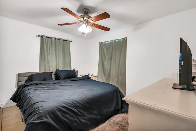 tiled bedroom featuring ceiling fan