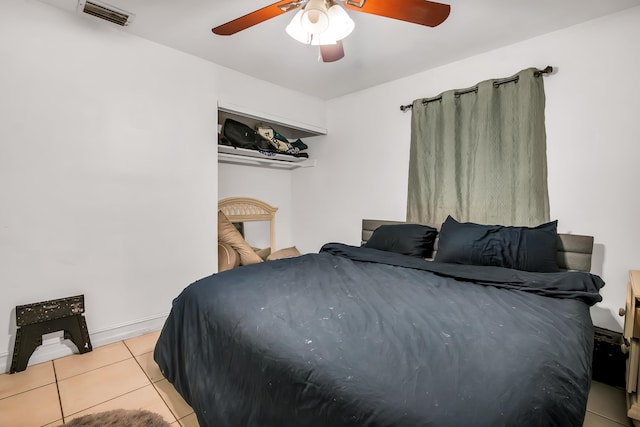 tiled bedroom with ceiling fan