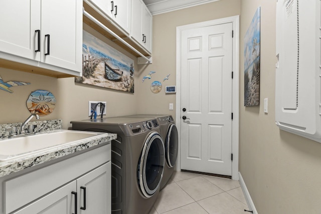 laundry room with separate washer and dryer, sink, cabinets, ornamental molding, and light tile patterned floors