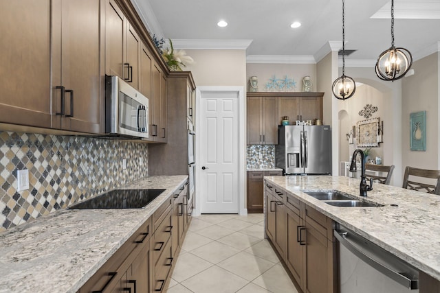 kitchen featuring tasteful backsplash, sink, stainless steel appliances, crown molding, and light stone countertops