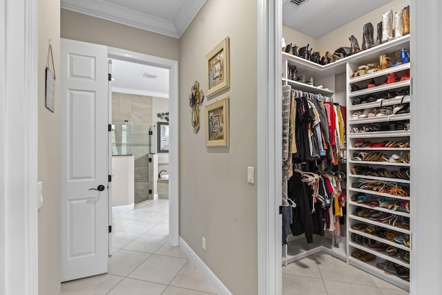 spacious closet with light tile patterned floors