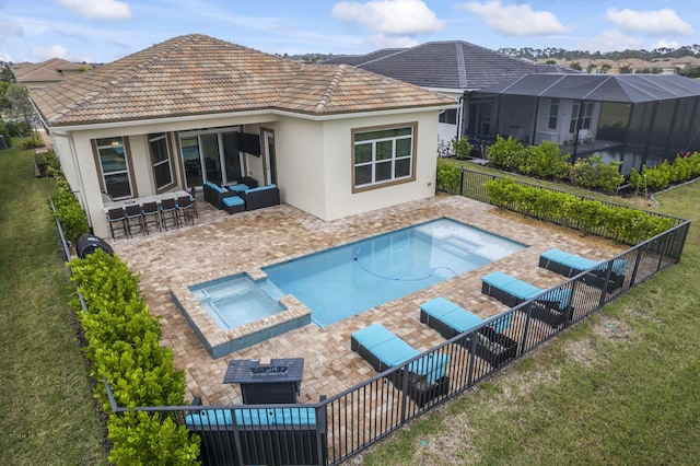 view of pool with exterior bar, an outdoor living space with a fire pit, a patio, and an in ground hot tub