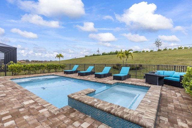 view of pool with an in ground hot tub, an outdoor hangout area, a lawn, and a patio area