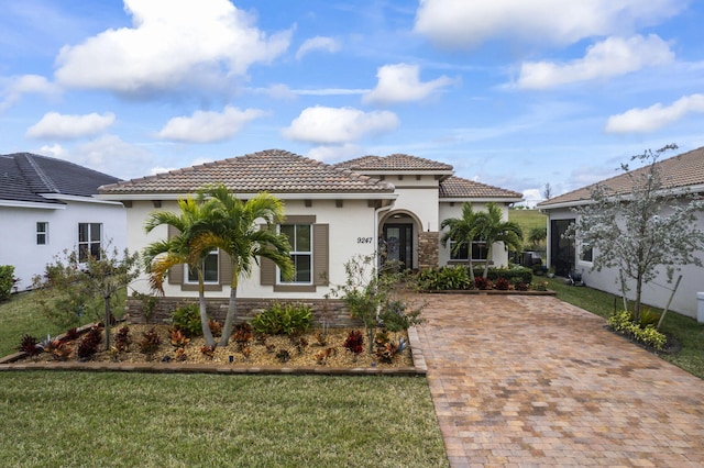 mediterranean / spanish-style house featuring a front lawn