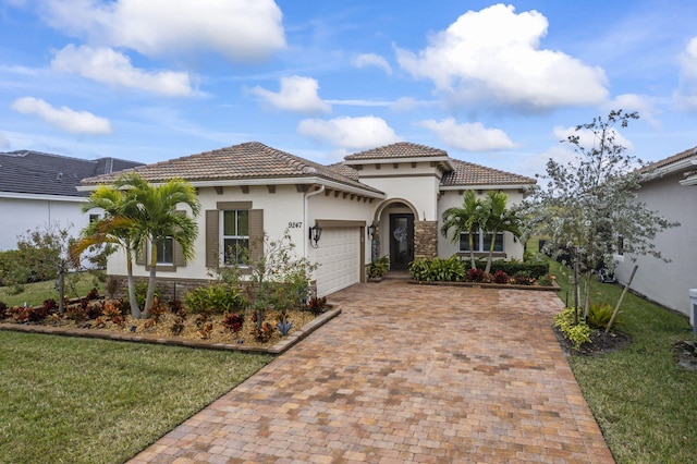 mediterranean / spanish-style home with a garage and a front yard