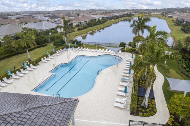 view of swimming pool with a patio and a water view