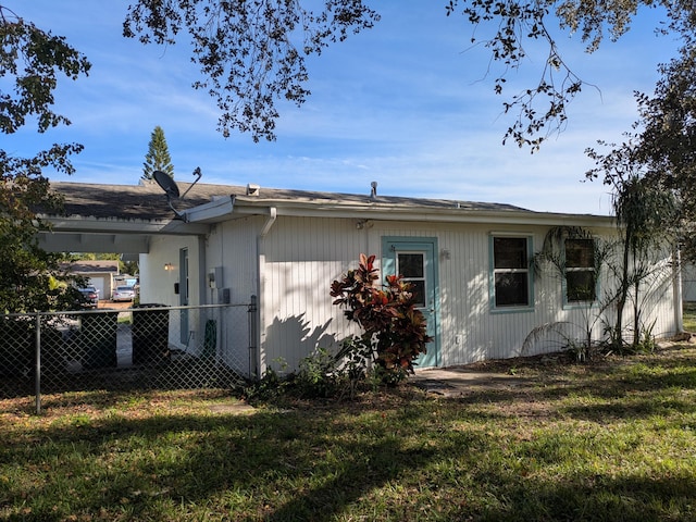 rear view of property with a yard