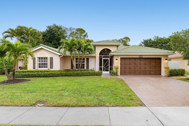 view of front of property with a garage and a front lawn