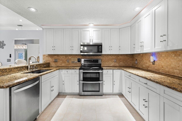 kitchen featuring sink, white cabinets, stainless steel appliances, and tasteful backsplash