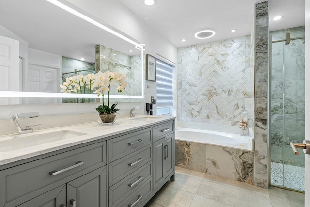 bathroom with independent shower and bath, tile patterned flooring, and vanity