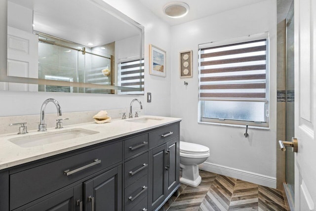 bathroom featuring vanity, toilet, parquet floors, and a shower with door